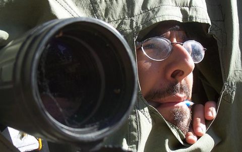 bird watcher looking out of a blind