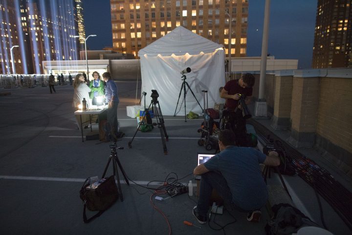 NYC Audubon staff and volunteers gather with scientists from the Cornell Lab of Ornithology on top of a parking garage near Wall Street to begin their vigil of monitoring birds at the Tribute in Light. Photo by Ben Norman.