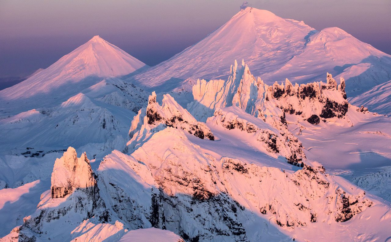 The Aghileen Pinnacles with Pavlof Sister, Pavlof Volcano, and Little Pavlof beyond, add to the outstanding wilderness qualities of the Izembek refuge. Photo by Gerrit Vyn.